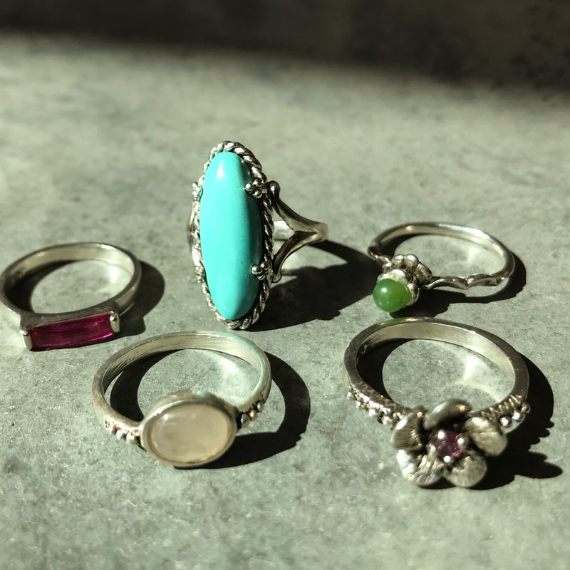 A selection of rings with various gemstones in the settings.