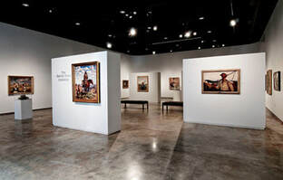 A gallery with paintings on movable walls.